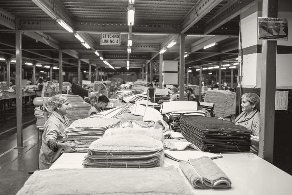 Textile workers sorting fabric in a factory, representative of the MSME manufacturing sector this case concerned.